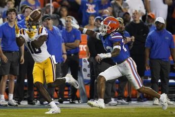 LSU wide receiver Jaray Jenkins, left, makes a reception in front of Florida cornerback Jaydon Hill for a 54-yard touchdown on Oct. 15 in Gainesville. (JOHN RAOUX/Associated Press)