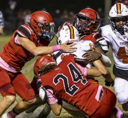 Lafayette linebacker Jalen Hill (5), safety Baylor Johnson (3) and linebacker Diego Garcia (24) tackle Trenton’s Brant Bivens on Friday night. (JACK HOWDESHELL/Special to the Reporter)