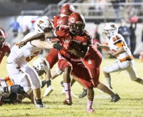 Lafayette running back Kiami McKnight run past a Trenton tackler last Friday. (JACK HOWDESHELL/Special to the Reporter)