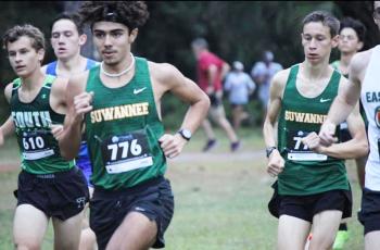 Suwannee’s Morgan Mobley races up the course with teammate Paul Gunter (right) at the Region 1-2A meet on Friday. (COURTESY)