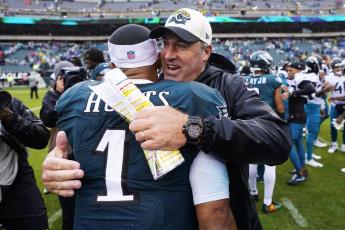Philadelphia Eagles quarterback Jalen Hurts is embraced by Jacksonville Jaguars head coach Doug Pederson after the Eagles defeated the Jaguars on Sunday in Philadelphia. (CHRIS SZAGOLA/Associated Press)
