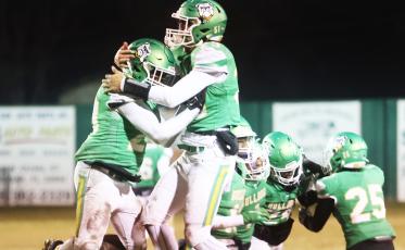 Suwannee’s Robert Robinson (left) and Blake Wynn (right) celebrate after Robinson recovered a fumble against West Florida during the Region 1-2S semifinals on Friday. (PAUL BUCHANAN/Special to the Reporter)
