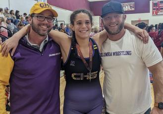 Columbia wrestler Carlee Morrison (middle) won the 145 class in the girls division at the Cam Brown Invitational on Saturday. (COURTESY)