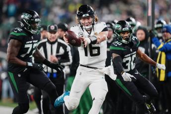 Jacksonville Jaguars quarterback Trevor Lawrence tries to get the ball across the goal line as he steps out of bounds against the New York Jets on Dec. 22 in East Rutherford, N.J. (FRANK FRANKLIN II/Associated Press)