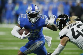 Detroit Lions running back D'Andre Swift rushes past Jacksonville Jaguars safety Andrew Wingard (42) during Sunday's game in Detroit. (DUANE BURLESON/Associated Press)