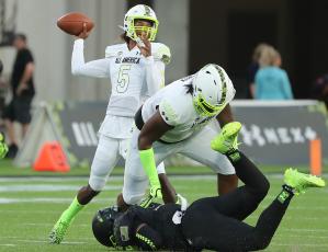 Jaden Rashada throws over the block of teammate Cayden Green during the Under Armour Next All-American Game at Camping World Stadium on Jan. 3 in Orlando. (STEPHEN M. DOWELL/TNS)