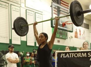 Columbia’s Sakiya Merriex completes her clean and jerk during the District 3-2A meet on Friday. (PAUL BUCHANAN/Special to the Reporter)