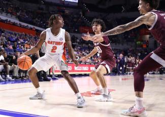 Florida guard Trey Bonham looks to pass out of a double team during Wednesday's game against Texas A&M in Gainesville. (MADDIE WASHBURN/UAA Communications)