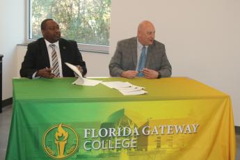 Florida Gateway College President Lawrence Barrett (right) and Santa Fe College President Paul Broadie II signed five articulation agreements Friday that will allow students at the colleges to continue their education at the other institution. (TONY BRITT/Lake City Reporter)