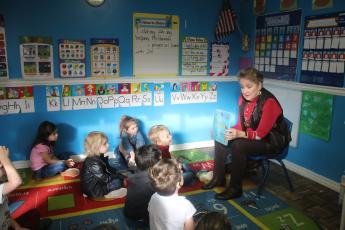 Ann Bormalini (right) reads ‘10 Little Fish’ to pre-kindergarten students at the My Little Red Schoolhouse Daycare on Friday morning. Rotarians visited several local public schools and private early childhood centers Friday as part of Rotary Readers. (TONY BRITT/Lake City Reporter)