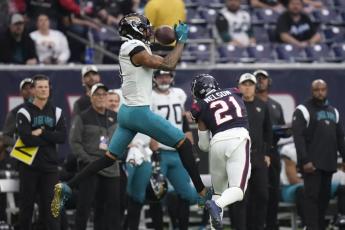 Jacksonville Jaguars wide receiver Marvin Jones Jr. (11) makes a catch over Houston Texans cornerback Steven Nelson (21) on Sunday in Houston. (ERIC CHRISTIAN SMITH/Associated Press)