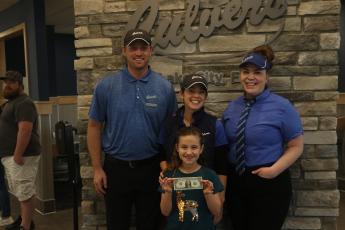 Tyler Goff (back from left), Bess Goff and Chelsea Culver pose with Olivia Medeiros, the Lake City Culver’s location’s first customer, along with the first dollar spent at the restaurant. (MORGAN MCMULLEN/Lake City Reporter)