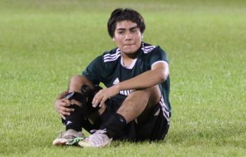 Suwannee’s Kendal Vasquez-Hernandez sits on the field dejected after the Bulldogs lost to Eastside 2-0 in the District 2-4A championship on Tuesday night. (MORGAN MCMULLEN/Lake City Reporter)