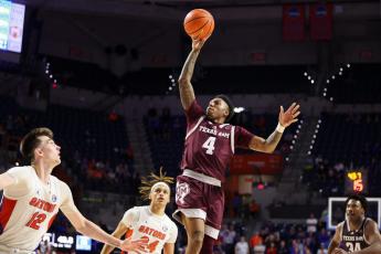 Texas A&M guard Wade Taylor IV makes a floater against Florida in the final minute of Wednesday's game in Gainesville. (COURTESY OF TEXAS A&M ATHLETICS)