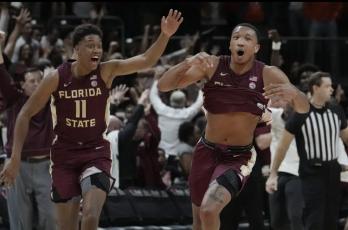 Florida State guard Matthew Cleveland (right) reacts after scoring the winning basket against Miami on Saturday in Coral Gables. Florida State defeated Miami 85-84. (MARTA LAVANDIER/Associated Press)