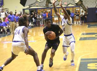 Columbia guard Isaac Broxey drives to the basket while defended by Mainland guard Jerel Moore (10) during Friday’s Region 1-5A final. (JORDAN KROEGER/Lake City Reporter)