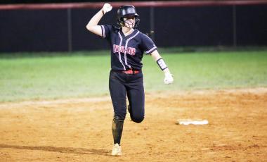 Fort White pitcher Kadence Compton celebrates on her way to third base after hitting a home run against Union County during last season’s Region 3-1A championship. (BRENT KUYKENDALL/Lake City Reporter)