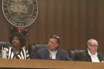 Live Oak Council President David Burch (center) responds to councilor Tommie Jefferson as fellow councilor Linda Owens looks on during Tuesday’s meeting. (JAMIE WACHTER/Lake City Reporter)