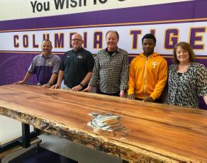 Trey Hosford (from left) Columbia High School principal, stands with Doug Peeler, Scott Stewart, Tray Tolliver and Jill Hunter, after Stewart donated a table he made to the school on Thursday afternoon. (COURTESY)
