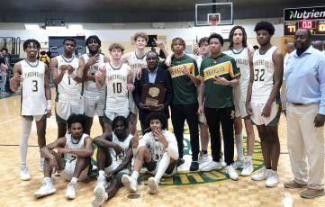 Florida Gateway College's basketball team poses with the South Atlantic District B championship trophy after defeating Pitt CC on Saturday. (JORDAN KROEGER/Lake City Reporter)