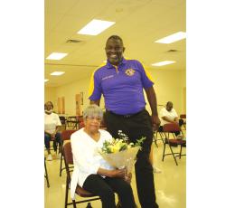 TONY BRITT/Lake City Reporter Francena Robinson Harris,103, holds a bouquet of flowers presented by Rev. Kyle Gibson, who recently visited the Olivet Missionary Baptist Church Health and Wellness group following one of its exercise classes. (TONY BRITT/Lake City Reporter)
