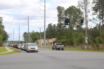 Cars sit at the intersection of Sisters Welcome Road and Bascom Norris Drive on Friday. (TONY BRITT/Lake City Reporter)