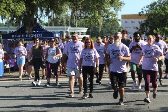 Grace Duncan’s parents, Burt and Cissy (center) help lead the start of last year’s Grace’s Race 5K. The third annual race is scheduled for Saturday at the Heritage Oaks Circle Shopping Center. (FILE)