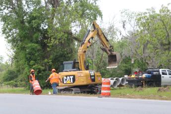 A crew with Anderson Columbia sets up barricades along the side of State Road 47 on Monday as work began on a widening and resurfacing project. (TONY BRITT/Lake City Reporter)