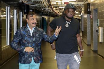 Jacksonville Jaguars owner Shad Khan walks first-round draft pick offensive lineman Anton Harrison (right) to a news conference on Friday in Jacksonville. (GARY MCCULLOUGH/Associated Press)