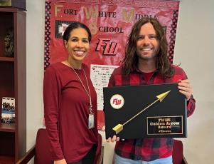 Nicole Bailey (from left), a Fort White High School assistant principal, presents Justin Jenkins, an eighth-grade science teacher, with the school’s inaugural Golden Arrow Award. The award is designed to recognize and honor any staff member that goes above and beyond their traditional job duties. (COURTESY)