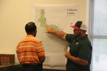 Lafayette County Building/Zoning Director Garrett Land (right) looks at the county’s future plan use map with Commission Chairman Earnest Jones during a workshop Tuesday on RV sites. (MORGAN MCMULLEN/Lake City Reporter)