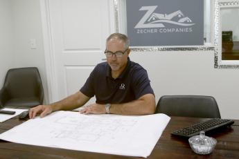 Bryan Zecher, looking over blueprints for a home in the Zecher Companies’ office on State Road 47, has been named the best Custom Builder in the U.S., according to the Avid Ratings’ annual awards, which are based on customer satisfaction surveys. (FILE)