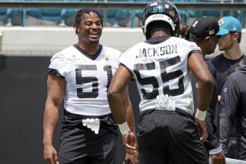 Jacksonville Jaguars linebacker Ventrell Miller (51) shares a laugh with linebacker Dequan Jackson (55) during the team's rookie camp on Friday in Jacksonville. (JOHN RAOUX/Associated Press)