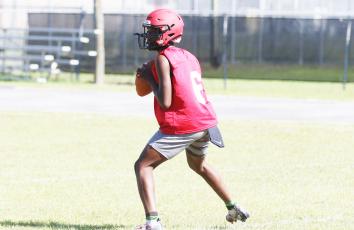Lafayette quarterback Tywan Williamson drops back to pass during practice on May 3. (MORGAN MCMULLEN/Lake City Reporter)