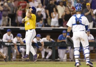 LSU's Cade Veloso celebrates as he approaches home plate after hitting a solo home run to take the lead against Florida in the 11th inning of Game 1 of the College World Series finals on Saturday in Omaha, Neb. (REBECCA S. GRATZ/Associated Press)