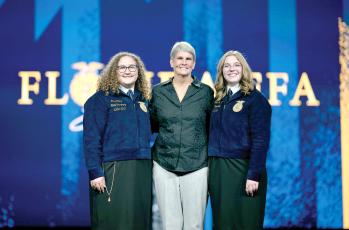 Former Fort White FFA advisor Jill Huesman (middle) was inducted into the Florida FFA Hall of Fame this week at the state convention. Huesman is pictured with FFA State President and Fort White High graduate Anelise Bullard (right) and FFA State Secretary Abby Kruse during the induction Tuesday. (COURTESY)