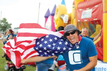 Earnest Burch waved down festival-goers with his Old Glory cape at the 2019 Independence Day event at the Columbia County Fairgrounds. After no festival a year ago, the City of Lake City and the Rotary Club of Lake City are bringing a full slate of activities to the banks of Lake DeSoto this year. (FILE)