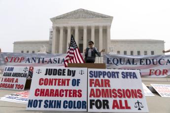 A person protests outside of the Supreme Court in Washington on Thursday. (JOSE LUIS MAGANA/Associated Press)