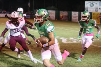 Suwannee’s Kodi Lang heads upfield against Madison County last season at Langford Stadium. The Cowboys are one of the seven playoff teams on the Bulldogs’ schedule this fall. (PAUL BUCHANAN/Special to the Reporter)