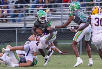 Suwannee running back Marquavious Owens tries to escape a tackle against Columbia during Friday night’s Preseason Classic. (BRENT KUYKENDALL/Lake City Reporter)