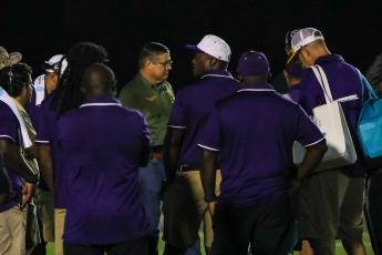 Columbia County Sheriff Mark Hunter talks will Columbia High and Buchholz High officials Friday night at Tiger Stadium. The season opener was postponed until Saturday night following two armed men climbing a fence at Tiger Stadium. (BRENT KUYKENDALL/Lake City Reporter)