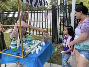 An Eastside Elementary School student is offered a cup of ‘jitter juice’ on Thursday, the first day of school. ‘Jitter juice’ makes the butterflies leave. (COURTESY)