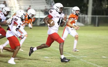 Fort White running back Maliki Clark takes a carry up the field against Trenton during last Friday’s jamboree. (PAUL BUCHANAN/Special to the Reporter)