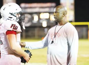 Fort White head coach Demetric Jackson talks with a player during Friday’s jamboree at Trenton. (PAUL BUCHANAN/Special to the Reporter)