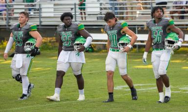 Suwannee captains Andrew Harrell (65), Justice Leggett (55), Kodi Lang (10) and Jadarius Cherry (56) walk out on to the field for the coin toss prior to last Friday’s Preseason Classic against Columbia. (BRENT KUYKENDALL/Lake City Reporter)