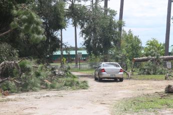 A road leading toward Suwannee High School is littered with fallen tree branches Thursday afternoon. Suwannee County Superintendent Ted Roush said there’s no definitive timeline for school to resume following Hurricane Idalia. (JAMIE WACHTER/Lake City Reporter)