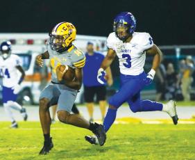 Columbia quarterback Xavier Collins scrambles up the field against Trinity Christian last Friday. (BRENT KUYKENDALL/Lake City Reporter)