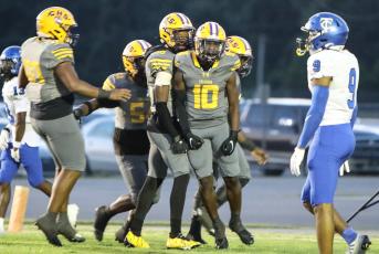 Columbia receiver Zamarion Jones celebrates with teammates after picking up yardage against Trinity Christian on Friday. (BRENT KUYKENDALL/Lake City Reporter)