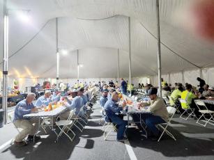 Linemen eat in the dining tent at the base camp at Suwannee Valley Electric Cooperative. Currently, more than 800 workers are being fed daily at the base camp on the co-op’s campus. (COURTESY SUWANNEE VALLEY ELECTRIC COOPERATIVE)