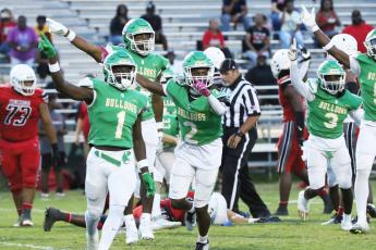 Suwannee defensive back PJ Davis (1), Amarion Rojas (2) and defensive end Ja’Darius Cherry (back) celebrate after their team’s fumble recovery against Munroe last Friday. (JAMIE WACHTER/Lake City Reporter)